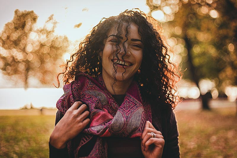 young adult female smiling outdoors in autumn